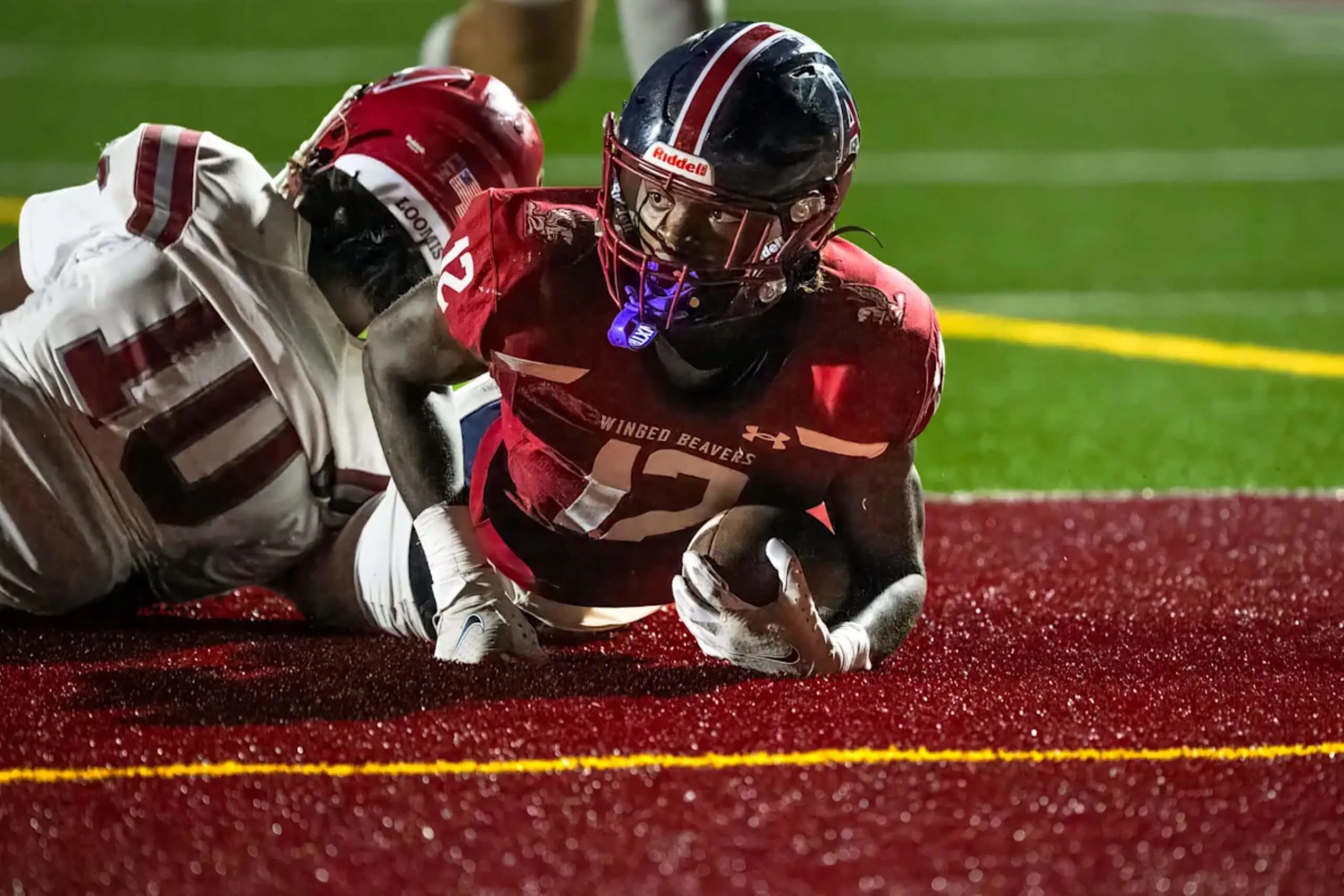 Avon Old Farms student playing football.