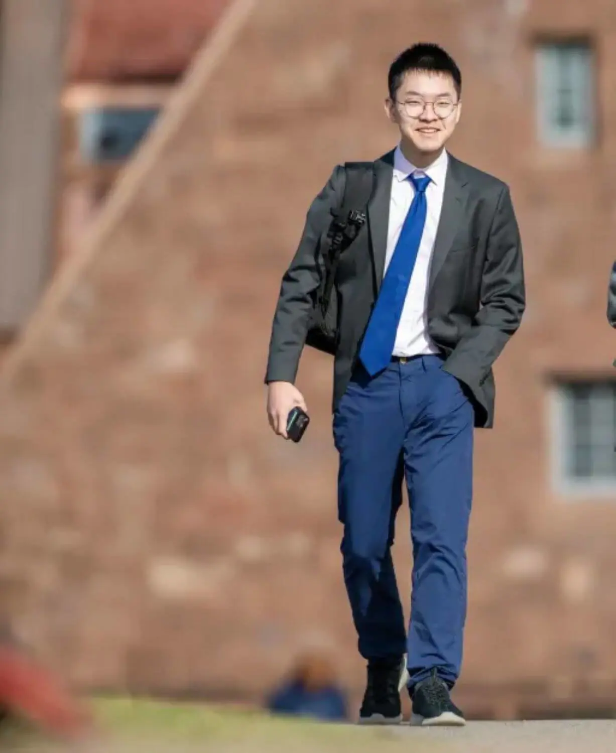 Roy Sun ’25 strolling through Avon Old Farms School's campus.