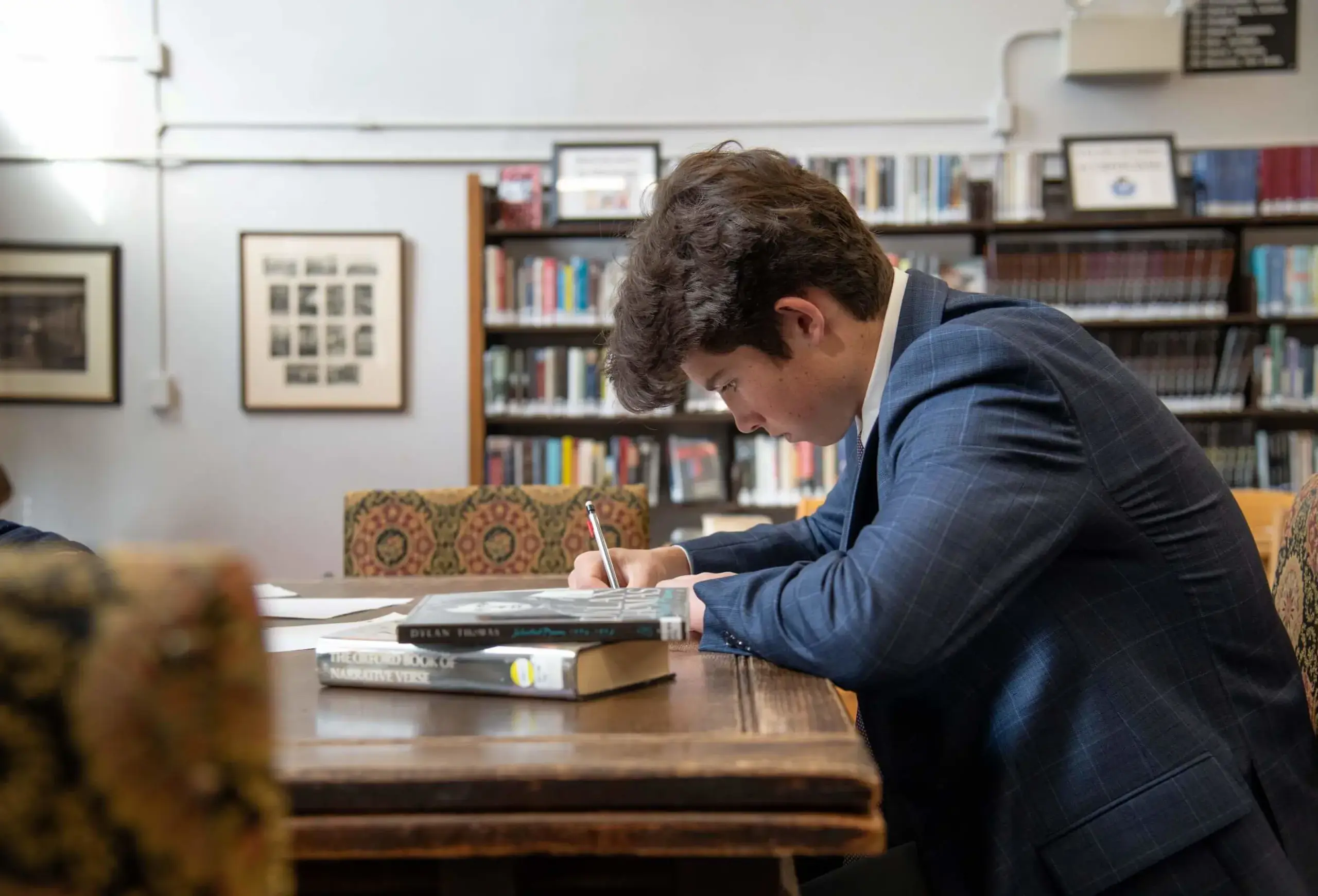 Avon Old Farms student studying in the library.