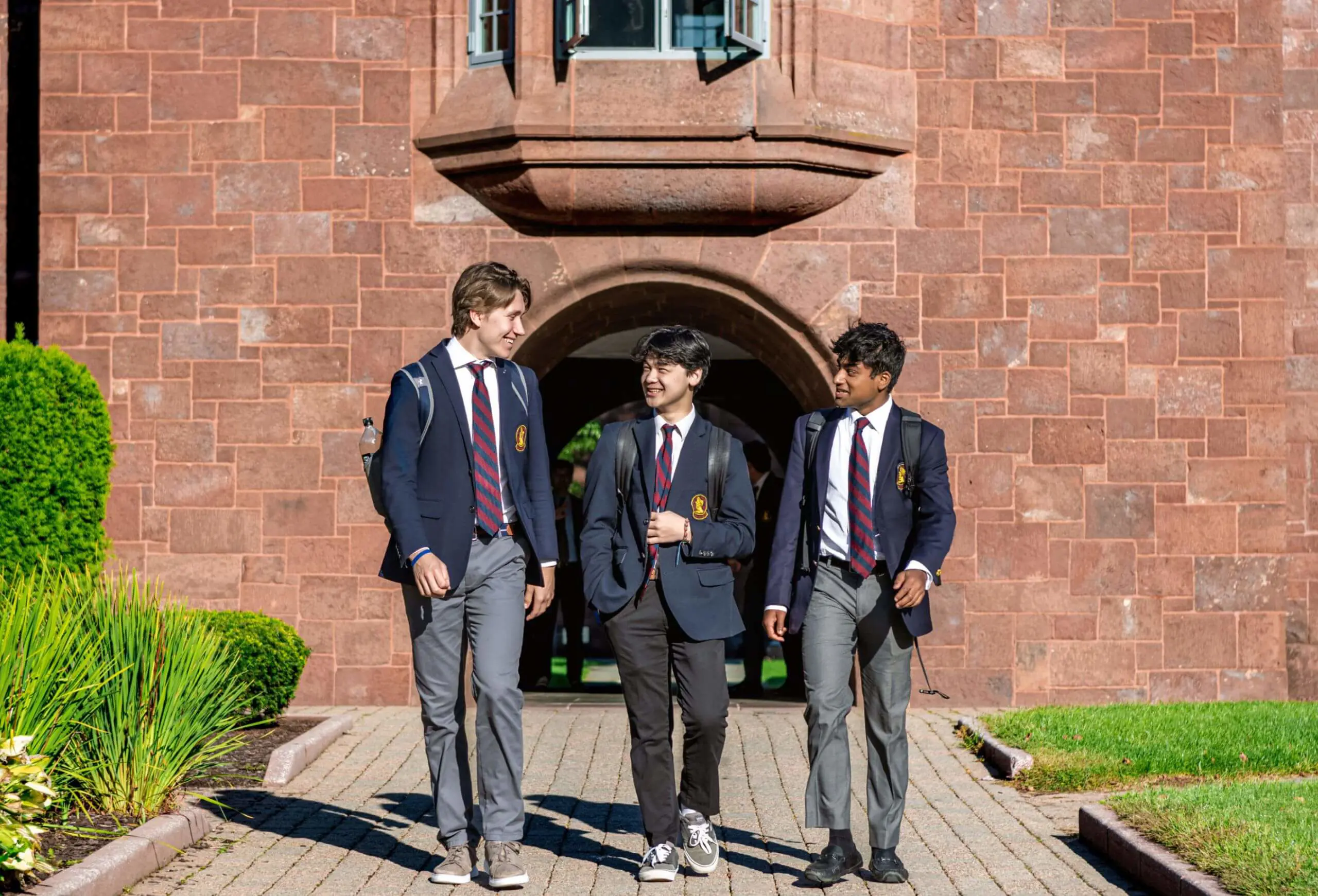 Avon Old Farms students walking to class together in the sunshine