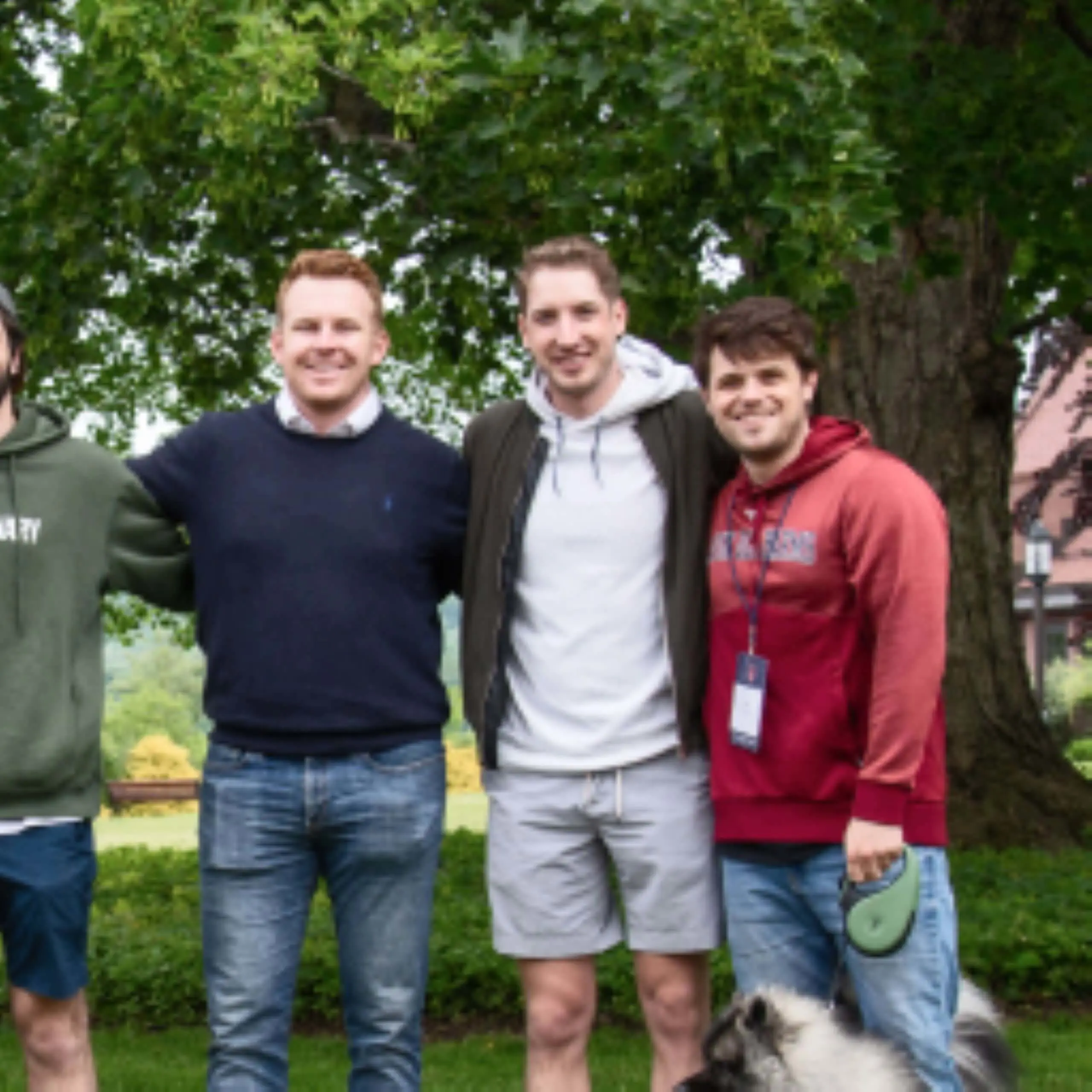 Avon Old Farms alumni posing for a photograph together outside.