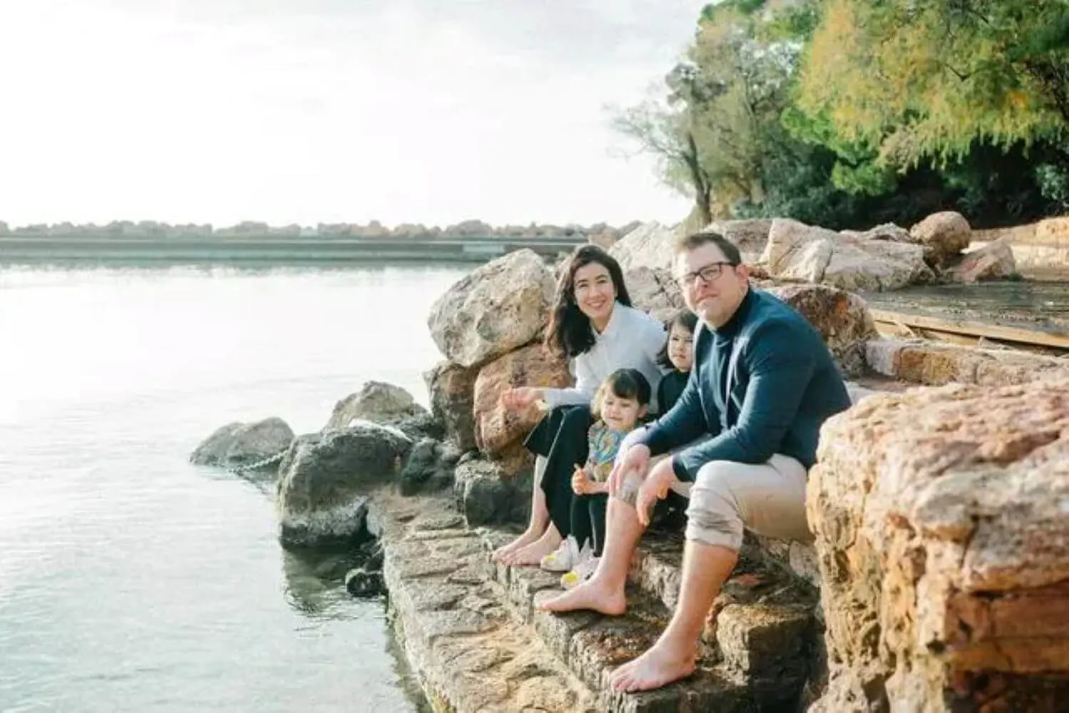 Anthony Crimmins ’01 with family sitting by a lake.
