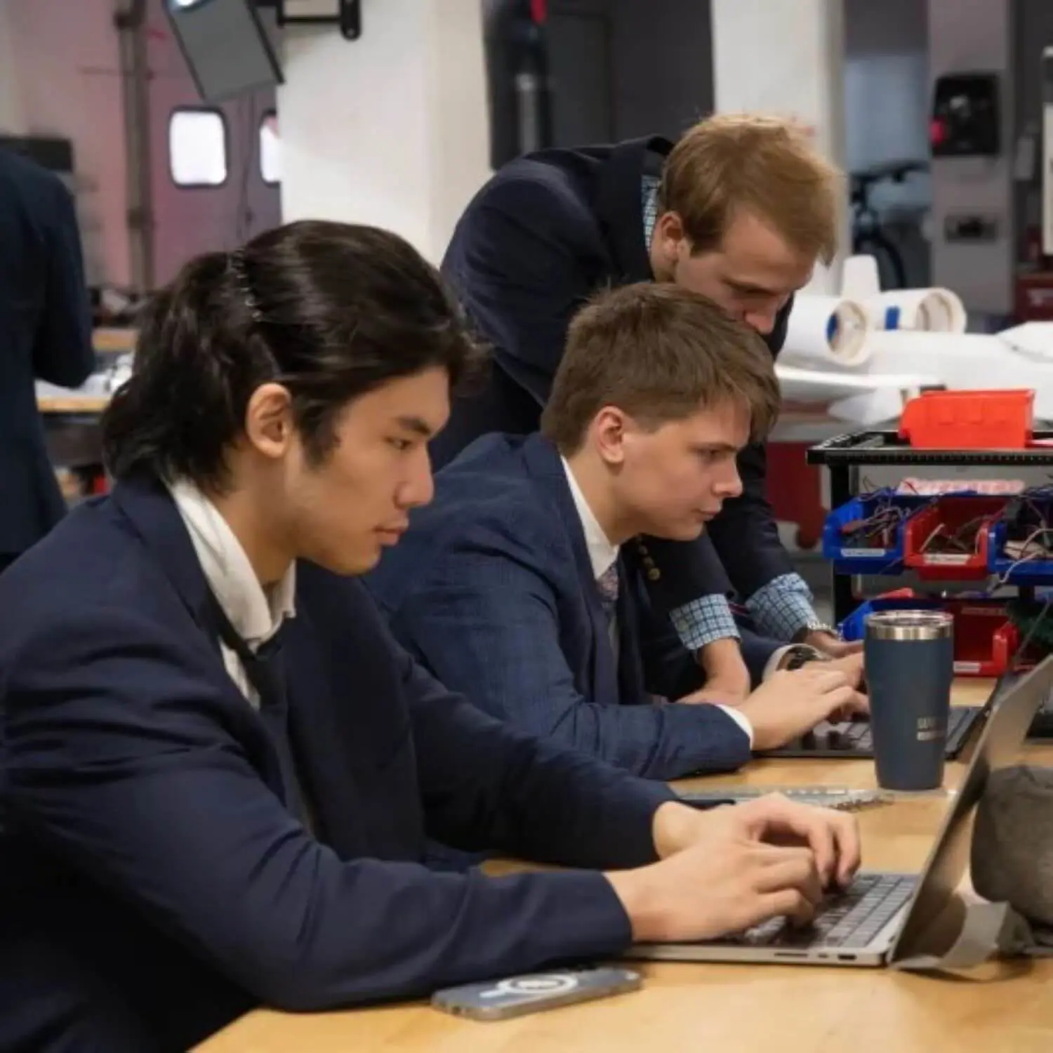Avon Old Farms students studying with laptops.