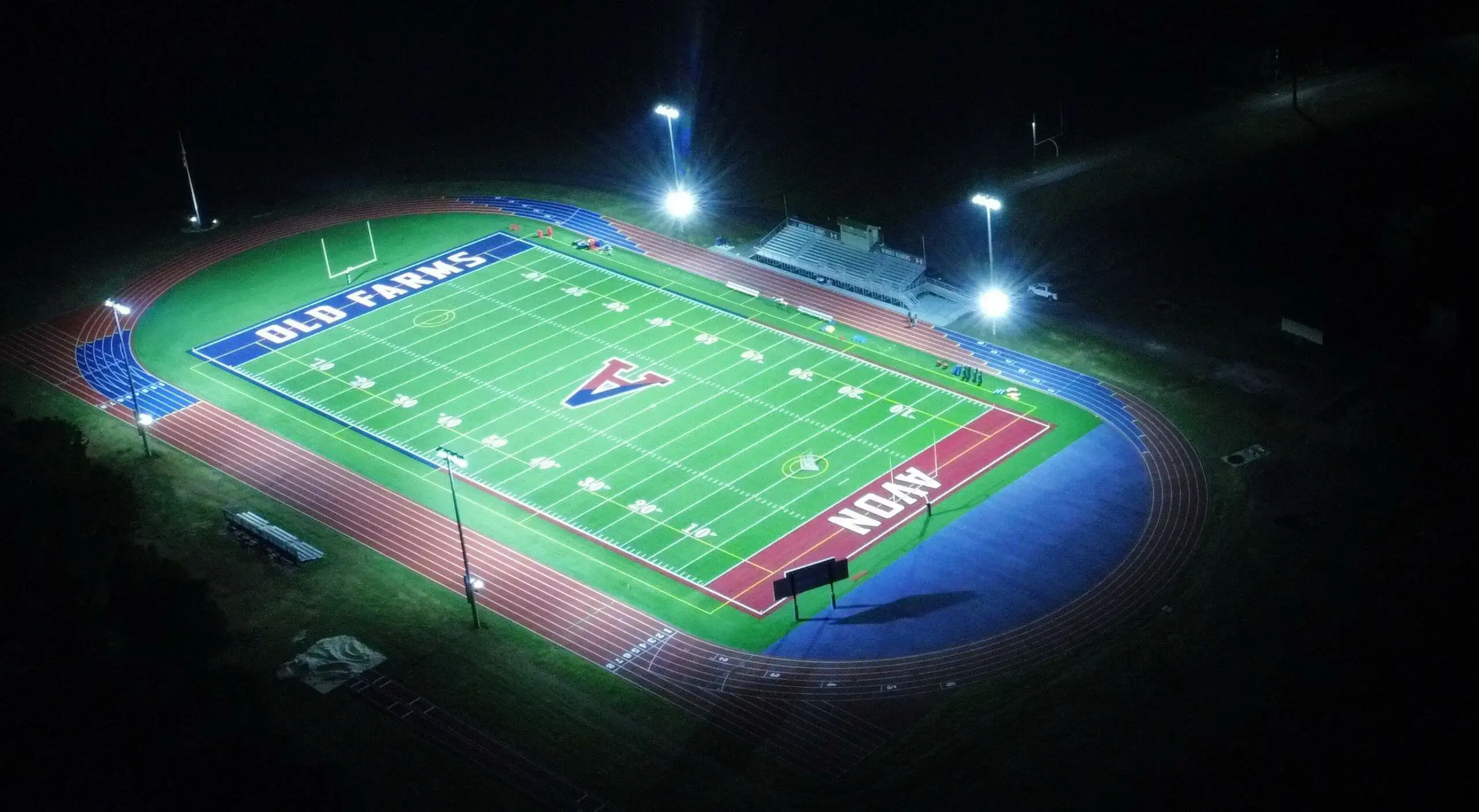 Avon Old Farms football field at night aerial photograph