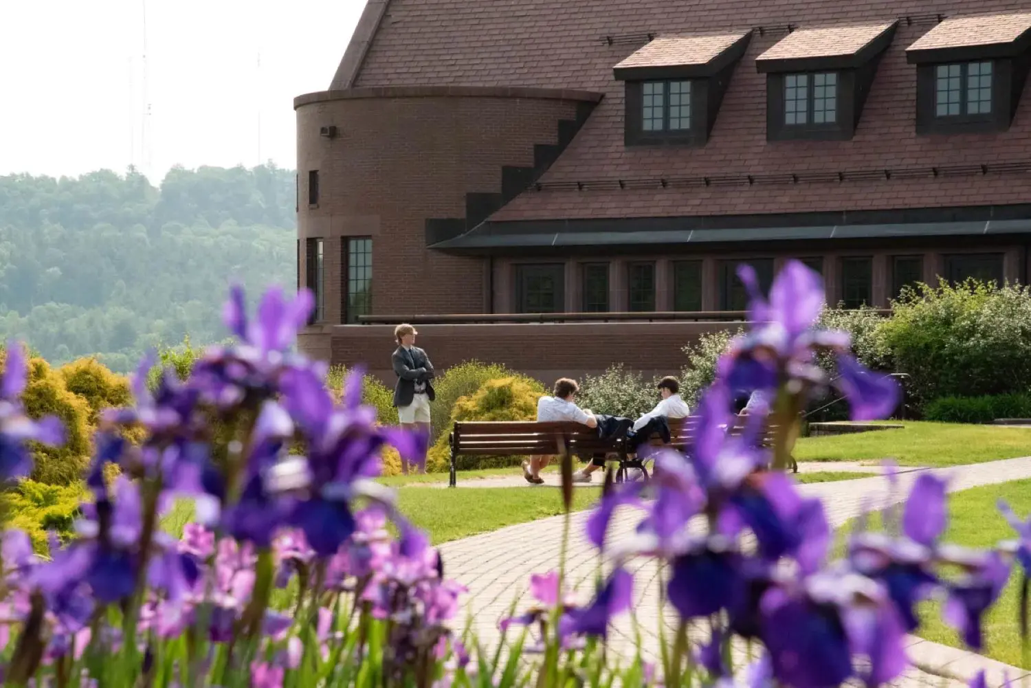 Avon Old Farms campus photograph with irises in foreground in the spring.