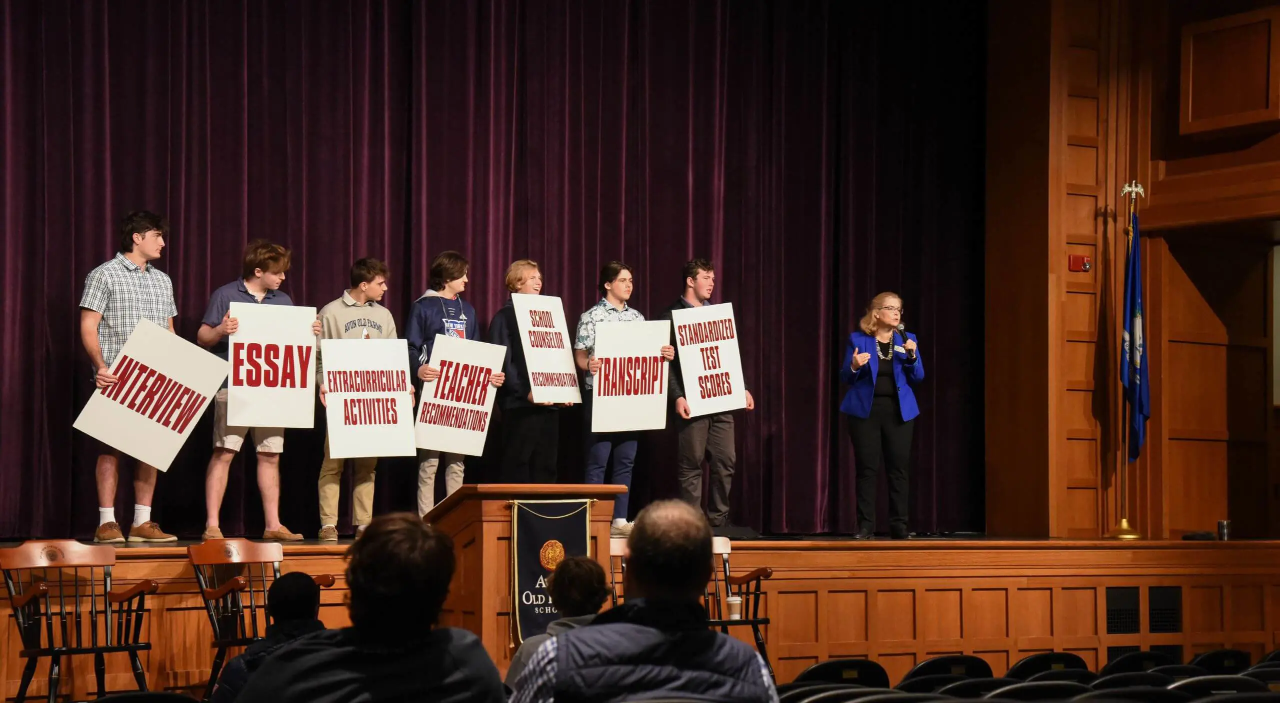 Avon Old Farms students taking part in a presentation on stage.