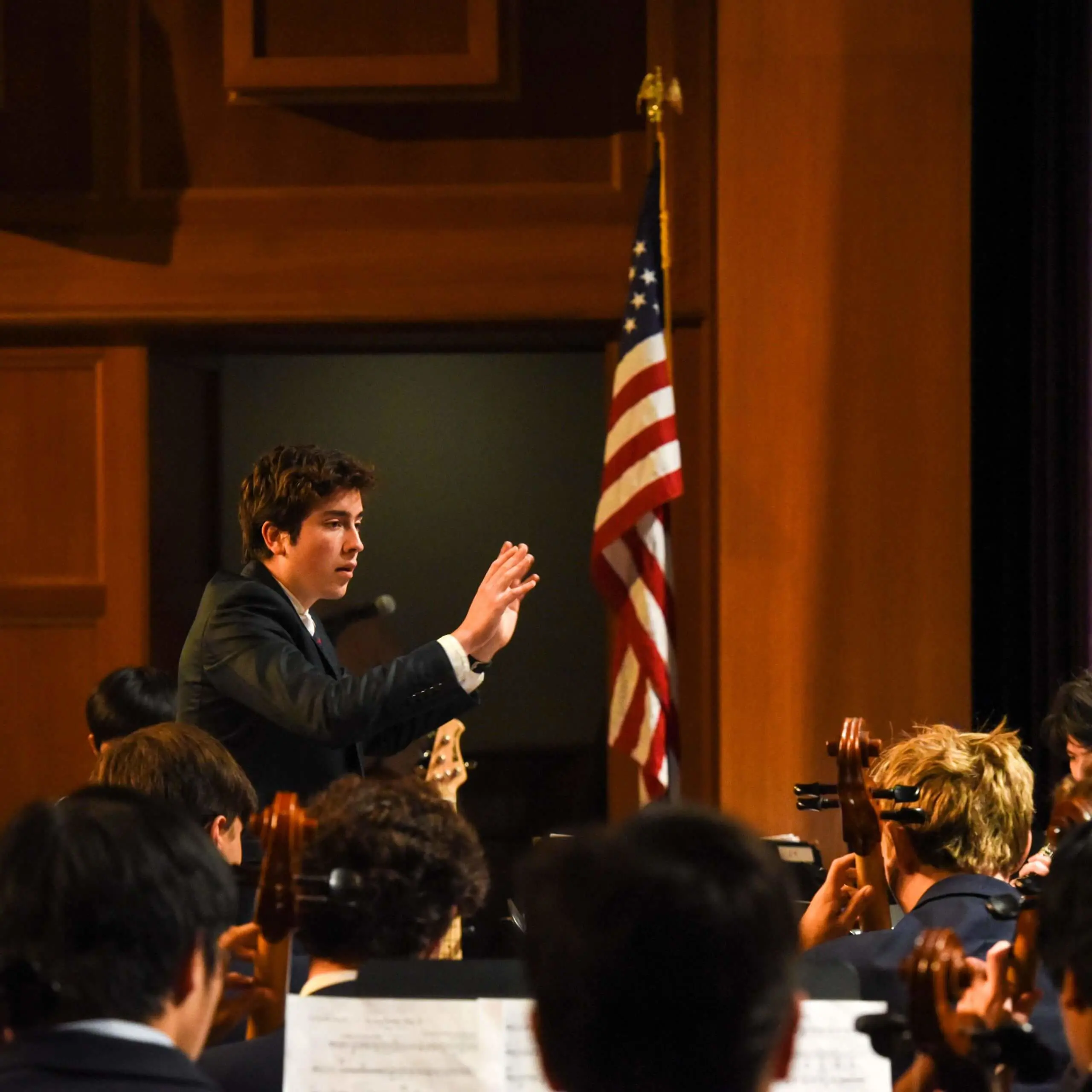 Avon Old Farms Student Band Director conducting at a concert
