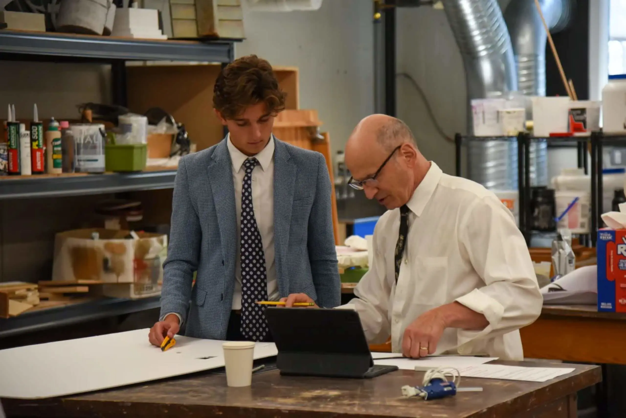 Avon Old Farms Art Teacher Greg Calibey with a student in class.