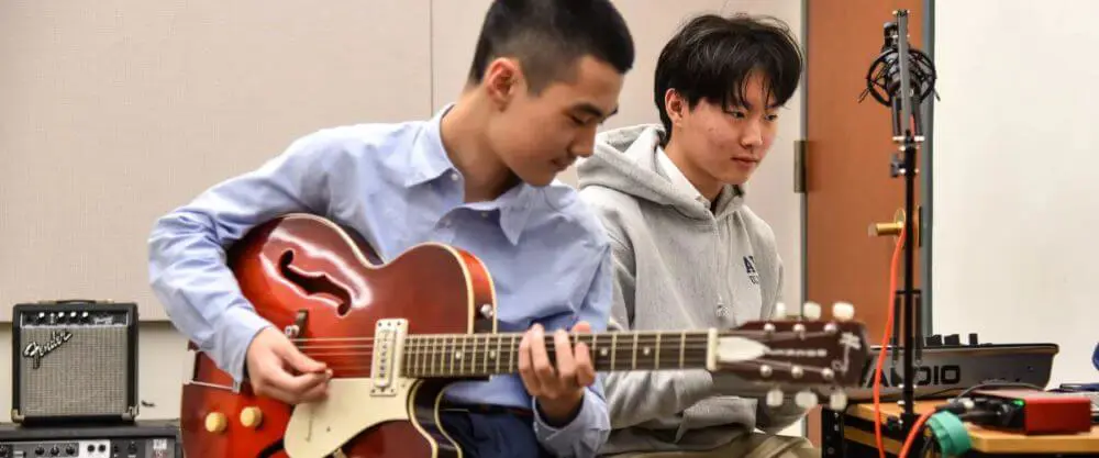Avon Old Farms students playing guitar and keyboard