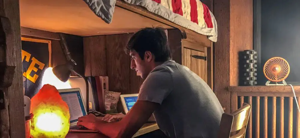 Avon Old Farms student studying at their desk in their dormitory.