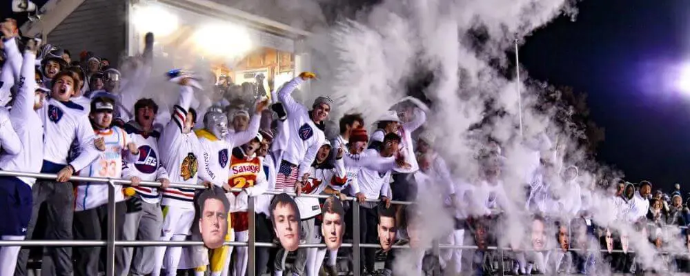 Avon Old Farms students cheering at a football game.