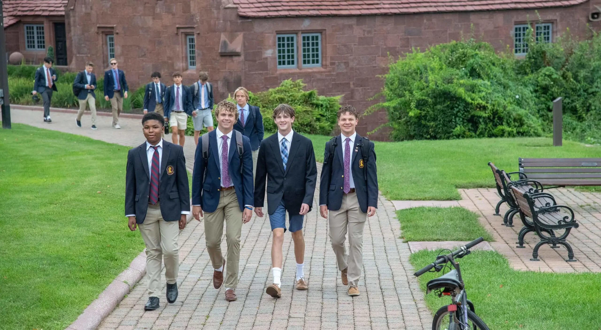 Four Boys Walk Together to Morning Meeting