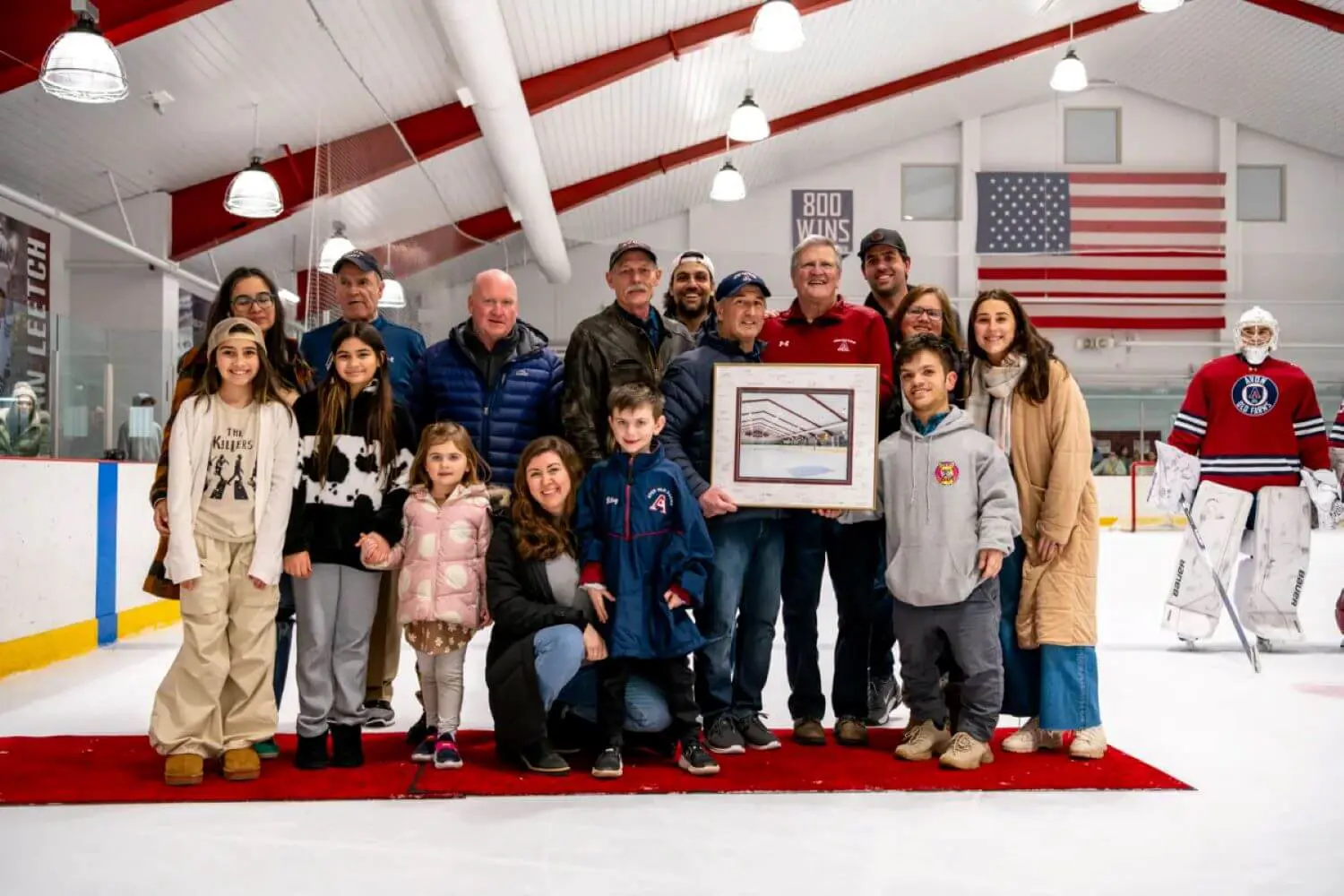 John Riley presented with an honorary diploma from Head of School Jim Detora P’12 as well as a framed photo of the JTG Rink.