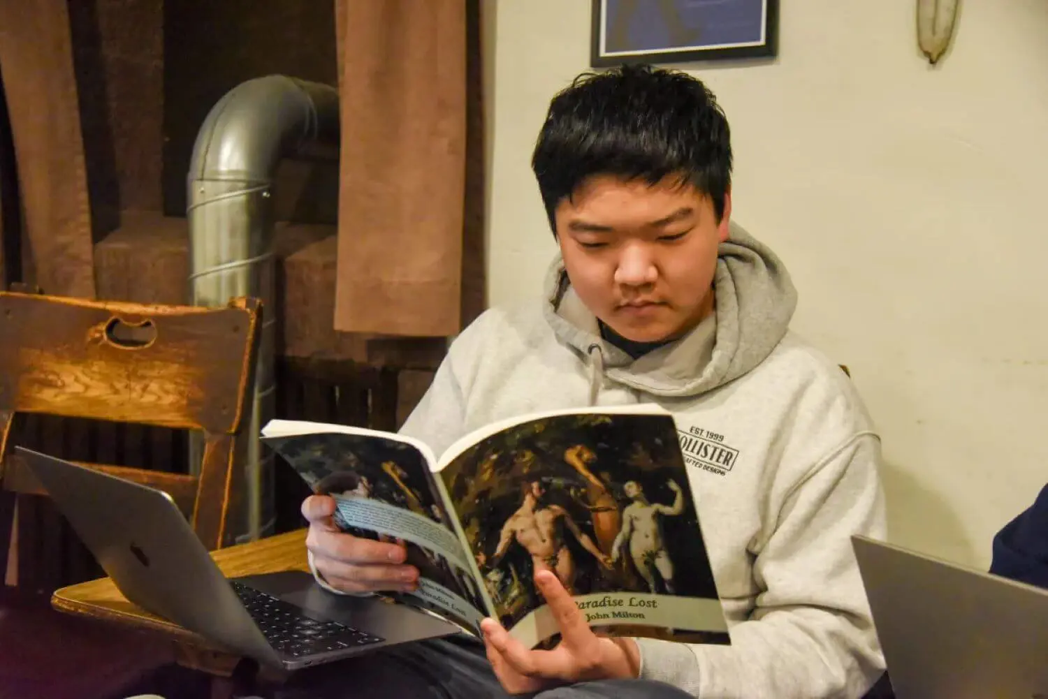 Joon Lee ’25 reading Paradise Lost by John Milton.