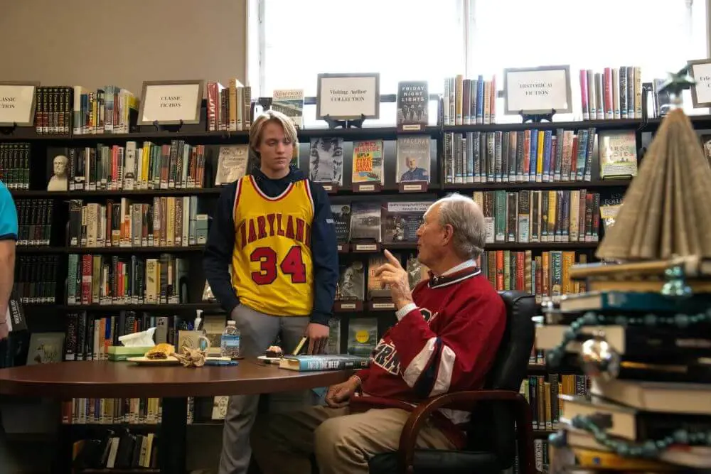 Visiting author Dr. Robert D. Ballard speaking to an AOF student in the library.