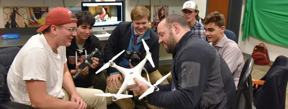Avon Old Farms students and teacher with a drone.