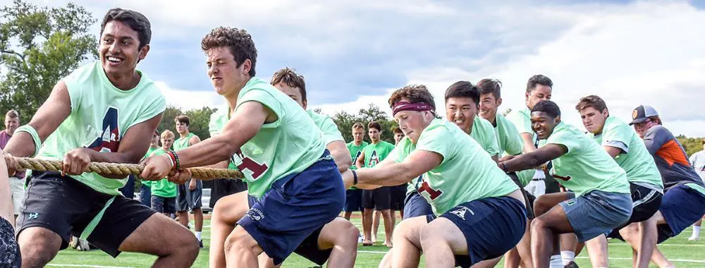 Avon Old Farms students playing tug-of-war.