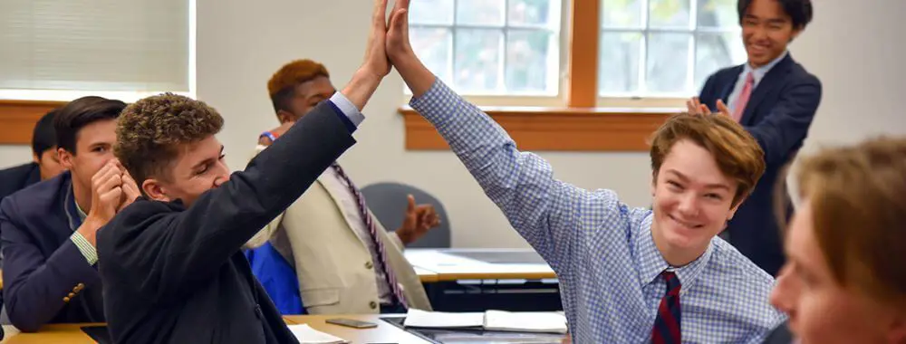 Avon Old Farms students high-fiving.