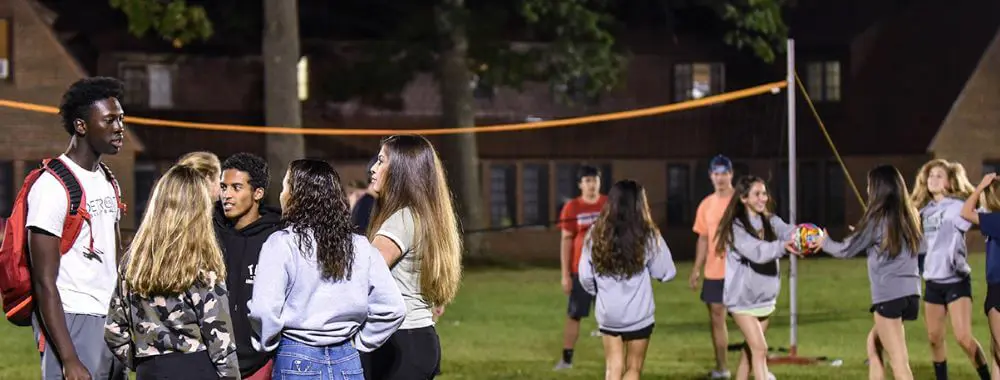Avon old Farms students playing Volleyball with students from a nearby girls' school.